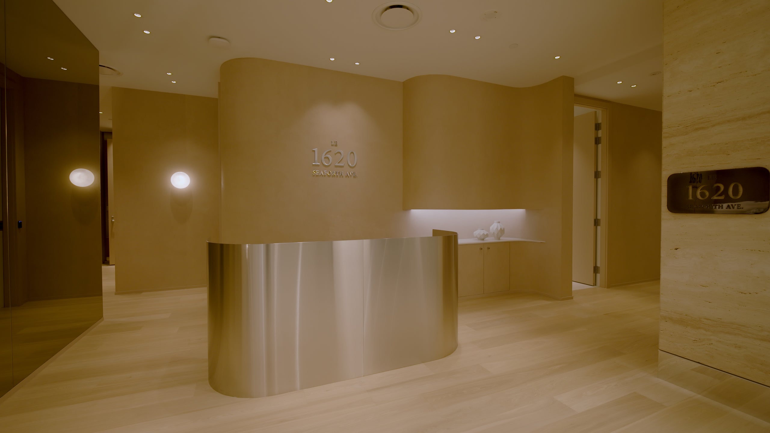 Modern interior with a curved reception desk and '1620' logo.