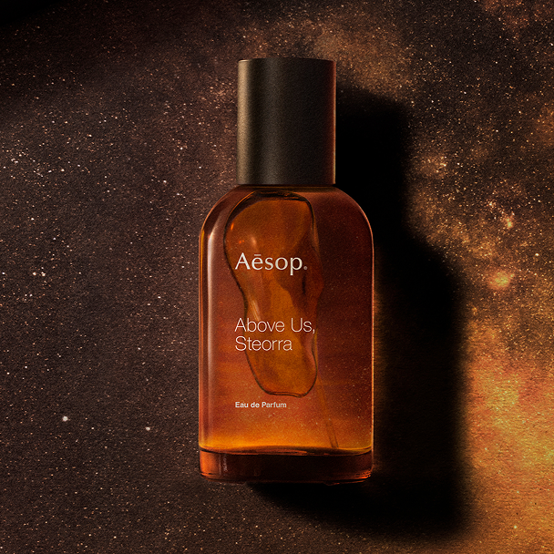 Aesop perfume bottle on a textured brown background