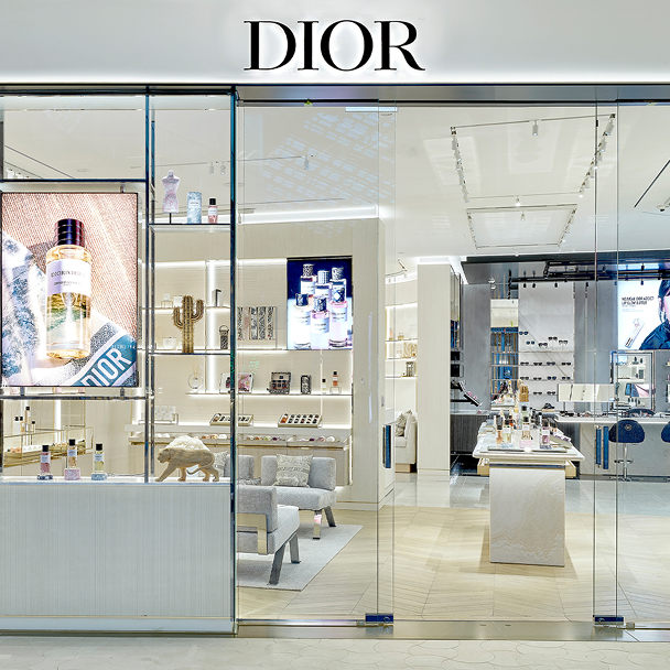 Dior store interior with glass walls displaying products and 'Dior' branding.
