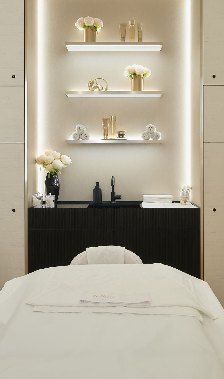 Modern interior with a black desk, white shelves, and decorative items.