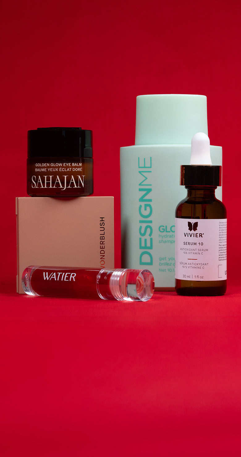 Collection of skincare and cosmetic products on a red background